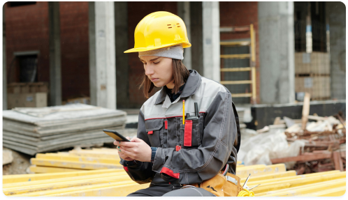 Woman at a construction site using Unite's Single Number Reach service.